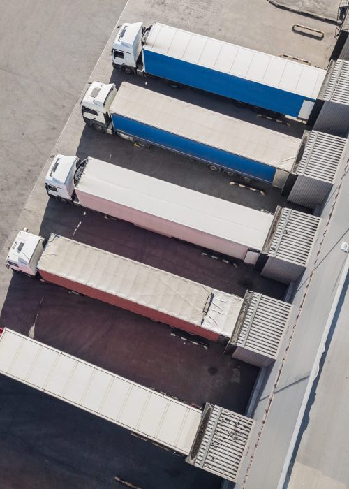 Aerial view of trucks unloading in logostics center